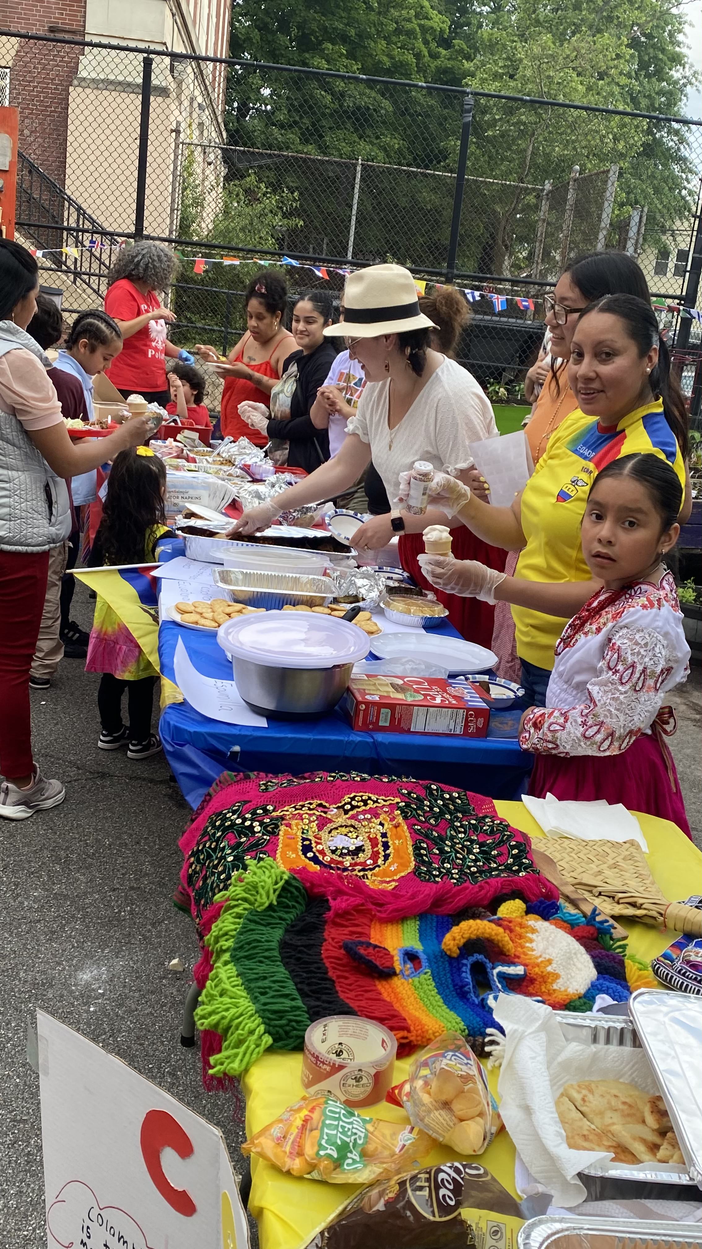 Women and children at a table with festive bowls and decorations.
